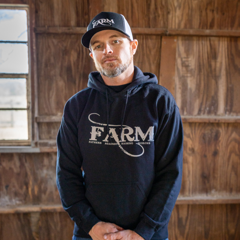 FARM black hoodie on ryan in barn